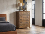 Tarvisio 37-Inch Rustic Caramel 5-Drawer Chest against a plaster wall in an industrial loft bedroom