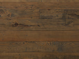 Close-up of the Tarvisio 37-Inch Rustic Caramel 5-Drawer Chest: rough-sawn pine boards with knots, saw marks and nail holes