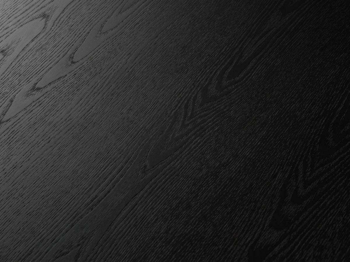 Close-up of the Taviano Black Wood Veneer Round Side Table: the black-stained open grain of the round top