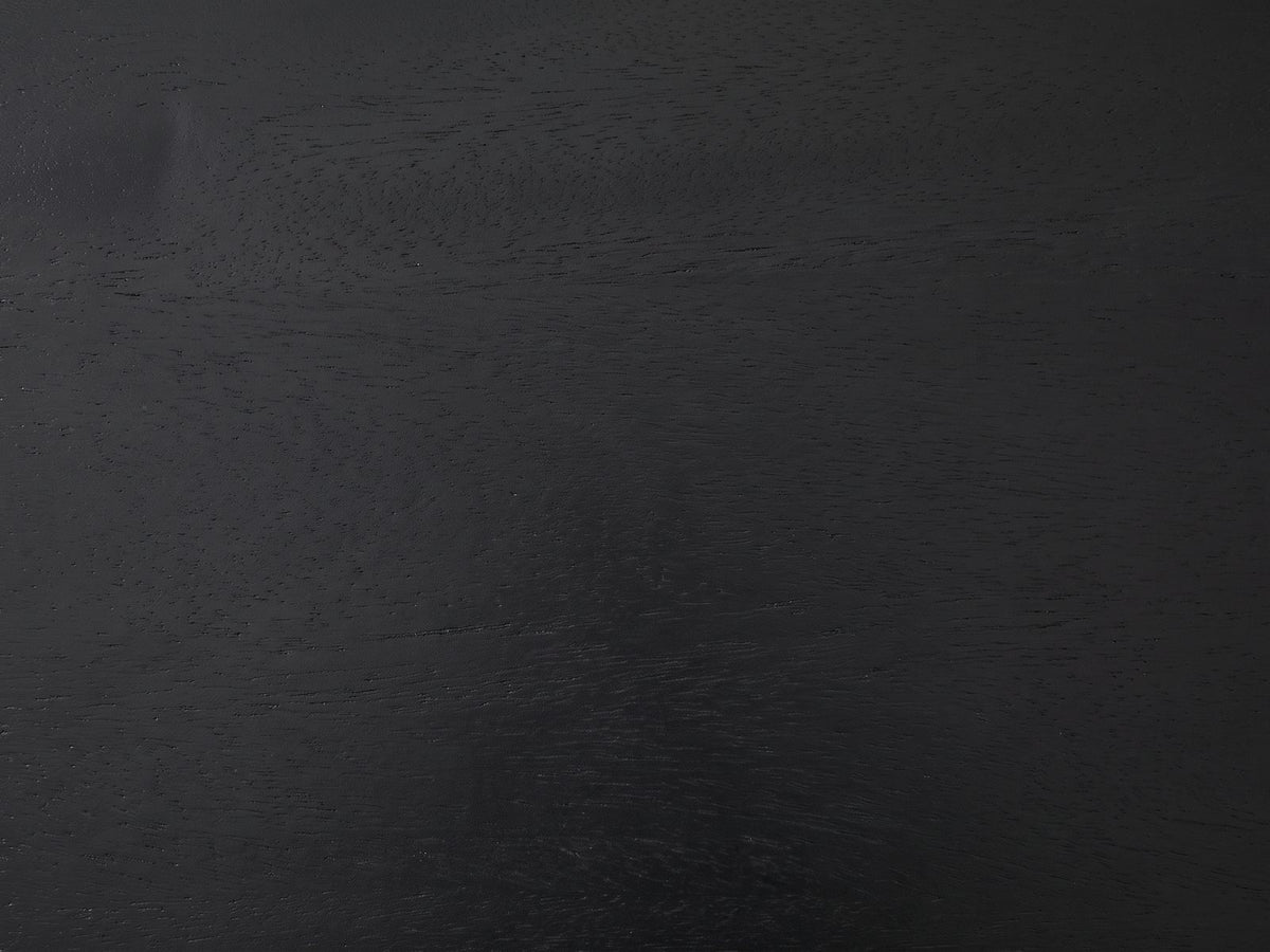 Close-up of the Teglio Black Acacia Faceted Octagon Side Table: the black-stained acacia grain of the octagonal top