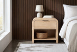 Tempio natural mango waterfall nightstand with a ceramic lamp and a seagrass basket beside a bed in a Denver bedroom with a dark walnut slat wall