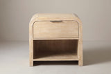 The Tempio nightstand in natural mango veneer, front view on a light studio backdrop