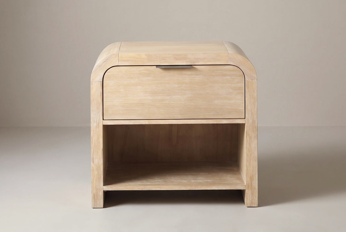 The Tempio nightstand in natural mango veneer, front view on a light studio backdrop