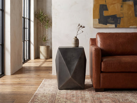 Terlizzi Graphite Cast Aluminum Faceted Side Table beside a leather sofa in an industrial loft