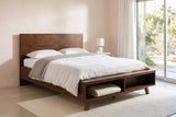 Termoli bed against a blush stucco wall in a Palm Springs bedroom with a sliding glass door onto a desert garden and a folded blanket in the open cubby