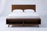 Termoli bed in walnut with a white mattress and pillows (not included), front view showing the two open cubbies