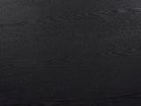 Close-up of the Terni Black Wood Veneer Fluted Pedestal Coffee Table: the open grain of the matte black top