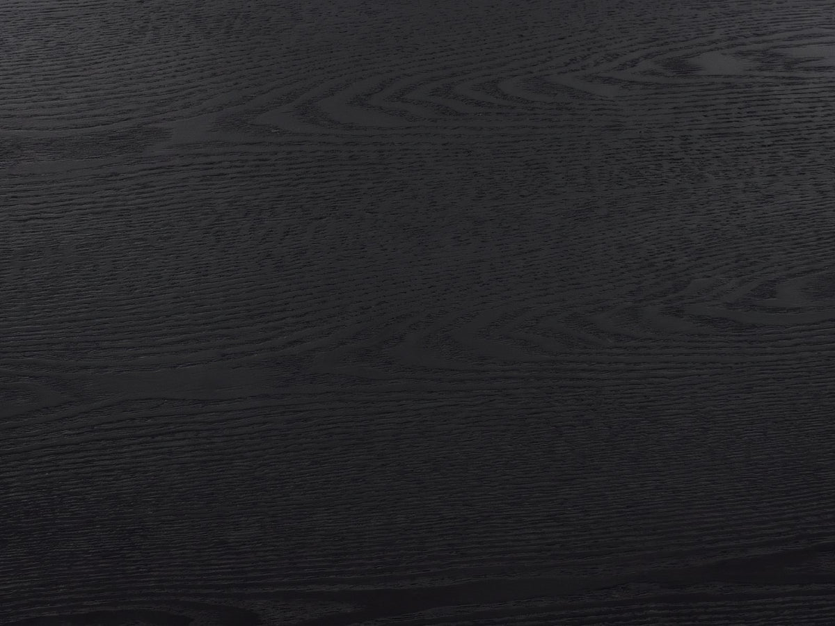 Close-up of the Terni Black Wood Veneer Fluted Pedestal Coffee Table: the open grain of the matte black top