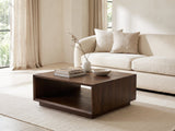 Terracina Solid Mango Block Coffee Table styled with books, a vase and a stone bowl in front of a cream sofa in a bright plaster room