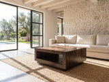 Terracina Solid Mango Block Coffee Table on a jute rug in front of a linen sofa in a poolside villa