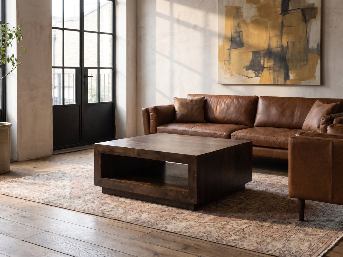 Terracina Solid Mango Block Coffee Table on a vintage rug in front of a leather sofa in an industrial loft