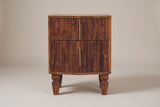 The Teulada nightstand in solid mango with a winewood finish, straight front view on a light studio backdrop