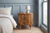 Thiesi reeded mango nightstand with a lamp against powder blue board-and-batten panelling in a Brooklyn bedroom