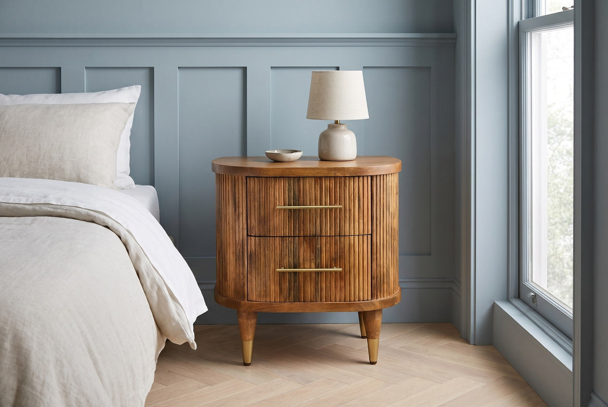 Thiesi reeded mango nightstand with a lamp against powder blue board-and-batten panelling in a Brooklyn bedroom