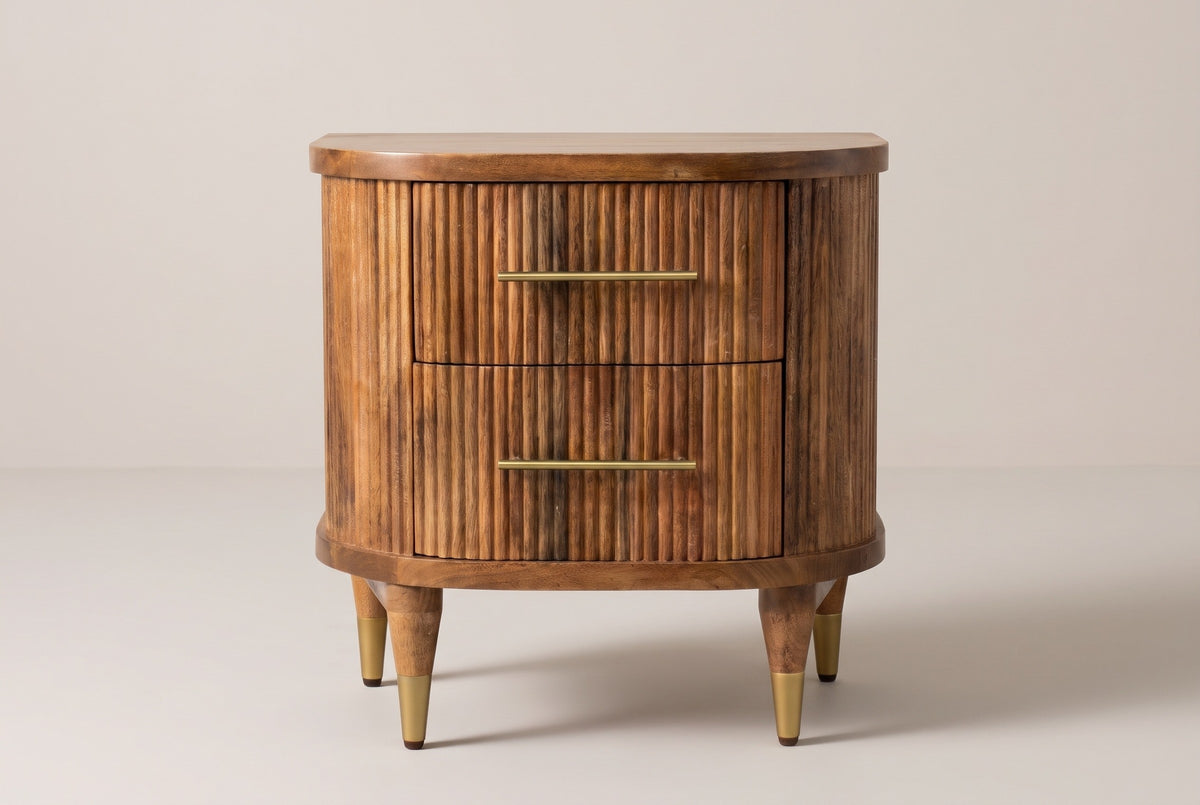 The Thiesi nightstand in golden brown reeded mango with brass pulls, front view on a light studio backdrop