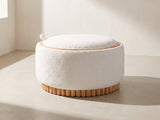 Tivoli Fluted Storage Ottoman in ivory against a plaster wall in morning light