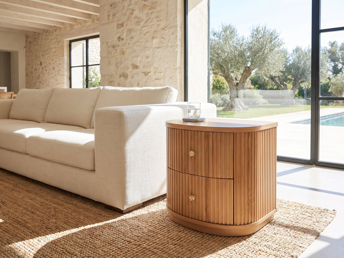 Tolfa Fluted Beech Half-Moon Side Table beside a linen sofa in a poolside villa