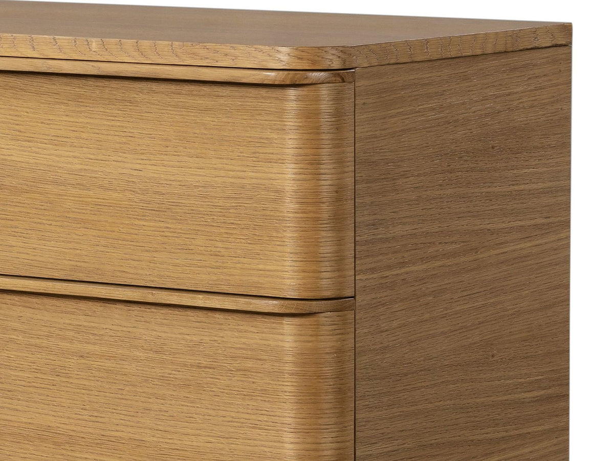 Close-up of the Tolmezzo 72-Inch Natural Oak 6-Drawer Dresser: the solid oak finger lips and the rounded outer ends of the drawer fronts