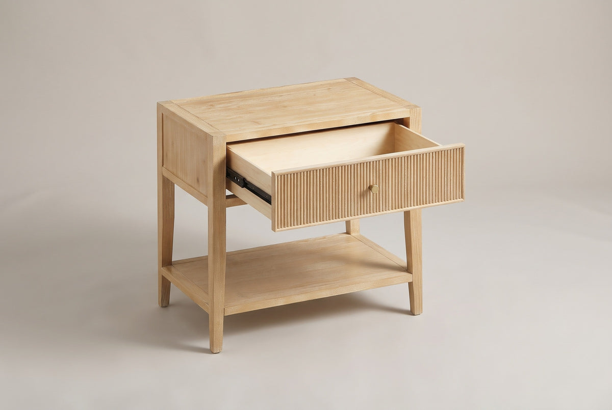 The Tonara nightstand with its one drawer pulled halfway open on metal glides, above the open lower shelf