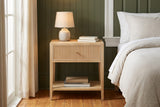 Tonara natural reeded nightstand against deep olive green wall panelling in a Savannah bedroom with heart-pine floors