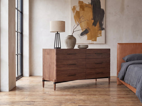 Torcello 68-Inch Walnut 6-Drawer Dresser against a plaster wall in an industrial loft bedroom