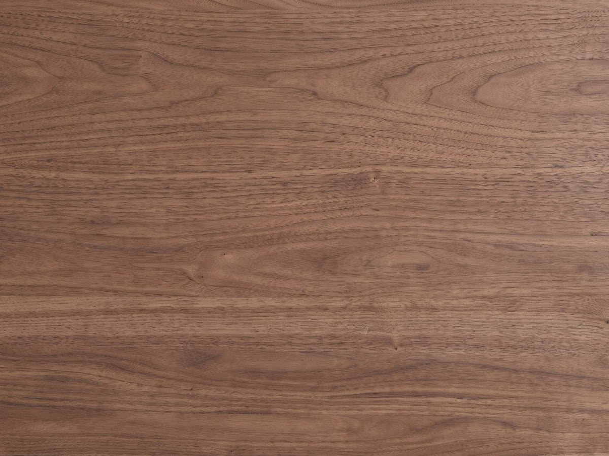 Close-up of the Torcello 68-Inch Walnut 6-Drawer Dresser: the walnut veneer with its natural cathedral and straight figure