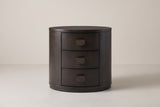 The Tortoli oval nightstand in deep espresso eucalyptus, front view on a light studio backdrop