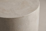 Close-up of the light grey MGO lightweight concrete at the eased top edge of the Trabia side table, showing soft trowel arcs and tiny pinholes
