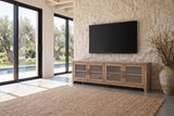 Tremezzo Washed Oak Media Console seen from the side in a poolside villa, the pool and olive trees through the doors