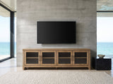 Tremezzo Washed Oak Media Console under a wall-mounted screen in an oceanfront glass house