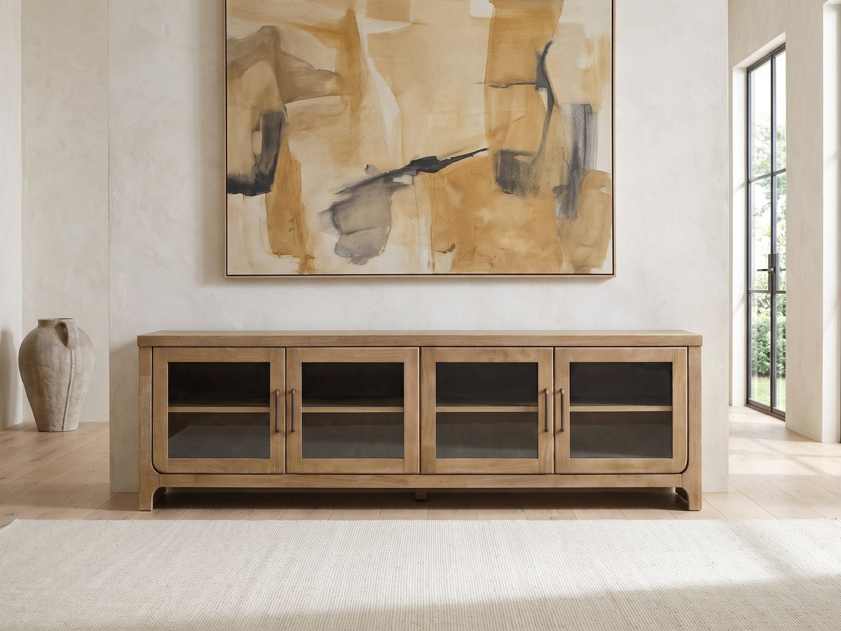 Tremezzo Washed Oak Media Console under a large abstract painting in a bright living room
