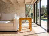 Tricarico Burl Veneer Scalloped Side Table beside a linen sofa in a poolside villa