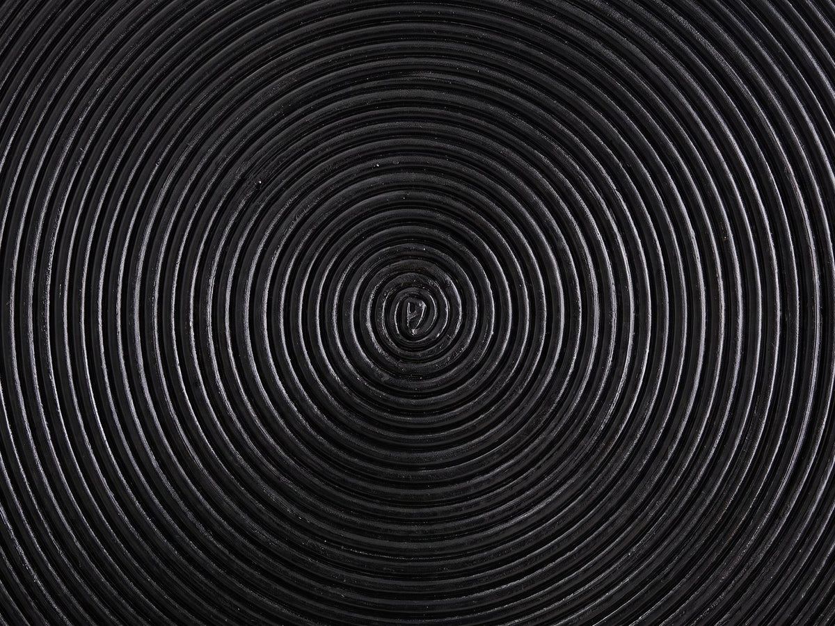 Close-up of the Tricase Black Rattan Hourglass Side Table: the spiral of rattan poles on the top
