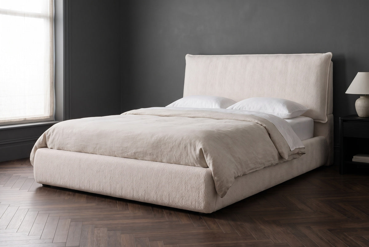 Trivento cream white chenille bed against a deep charcoal plaster wall in a Brooklyn brownstone bedroom with a herringbone walnut floor and a black-oak side table