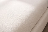 Close-up of the cream white chenille on the Trivento bed, curving over the rounded edge of the base