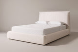 The Trivento pillow headboard bed in cream white chenille with a white mattress and pillows (not included), three-quarter view on a light studio backdrop