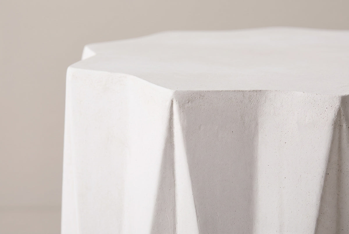 Close-up of the antique white lightweight concrete on the Troina side table, a star point and the crease below it