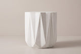 The Troina side table seen straight from the side: tall triangular facets and the plain band at the base