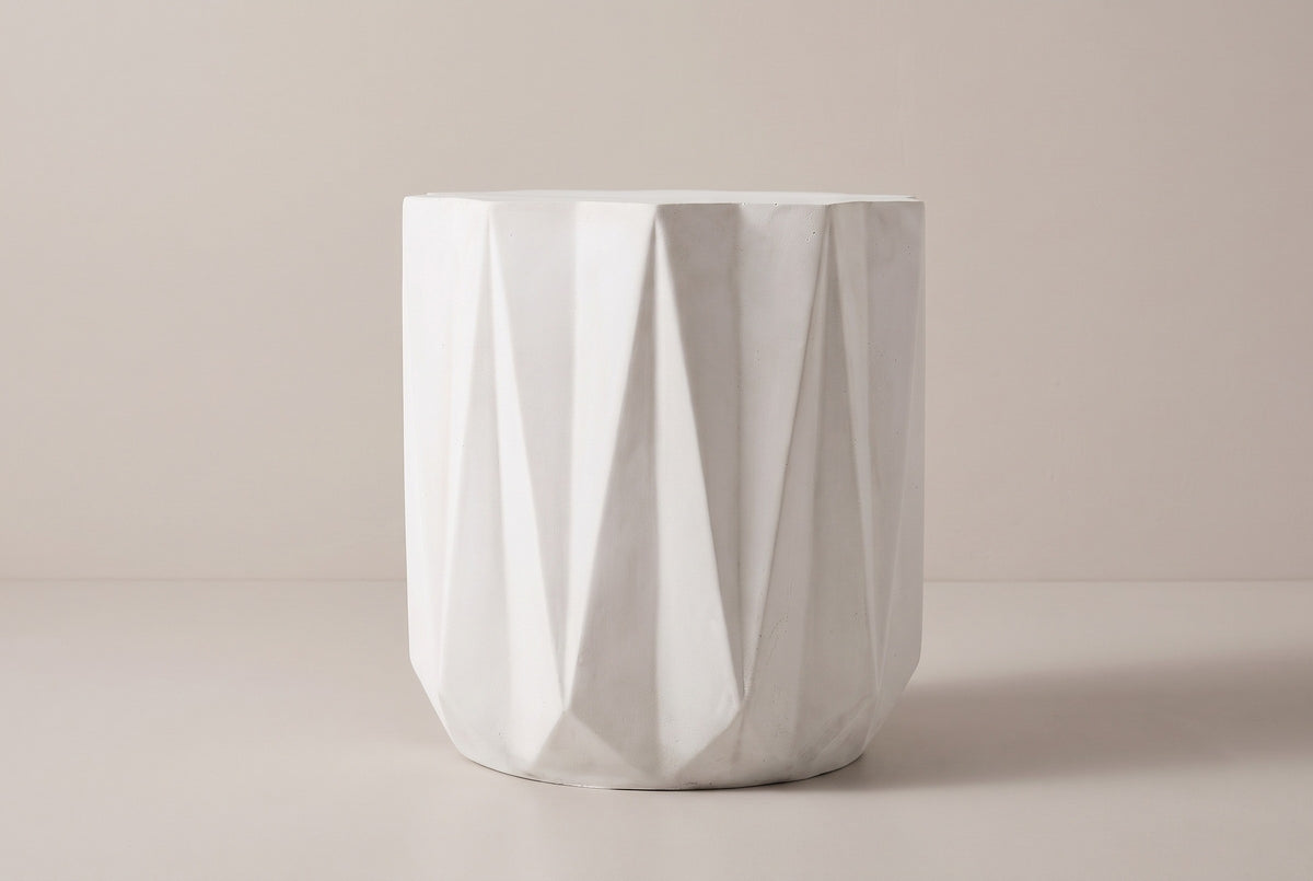 The Troina side table seen straight from the side: tall triangular facets and the plain band at the base