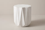 The Troina antique white faceted concrete side table, three-quarter view on a light studio backdrop