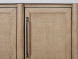 Close-up of the Tropea 54-Inch Round Extending Mindi Veneer Dining Set with 4 Chairs and Server: a cane door, a bronze bar pull and the white cement top of the included server