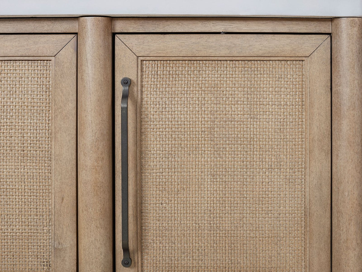 Close-up of the Tropea 54-Inch Round Extending Mindi Veneer Dining Set with 4 Chairs and Server: a cane door, a bronze bar pull and the white cement top of the included server