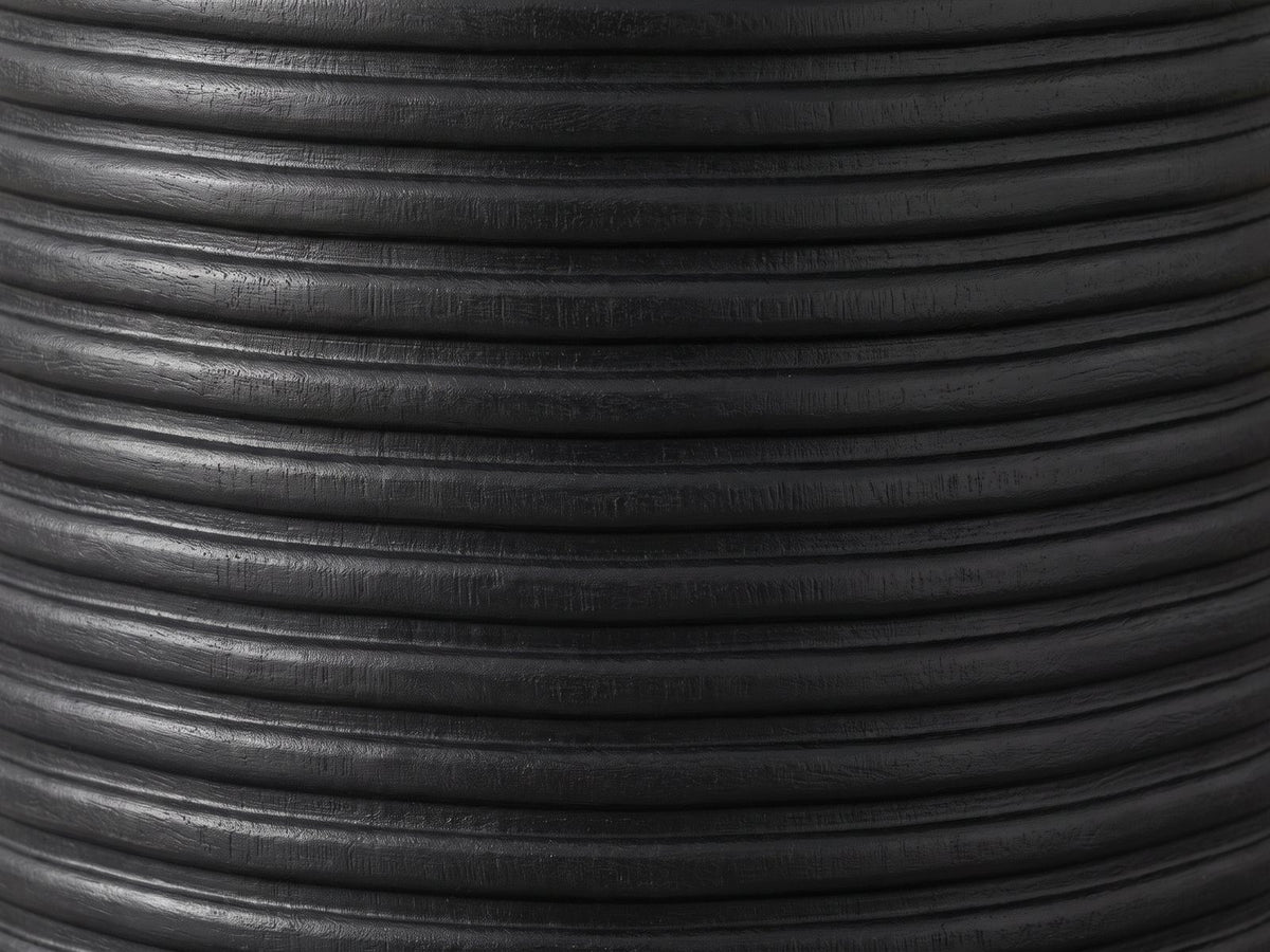 Close-up of the Tursi Black Mango Ribbed Pedestal Side Table: the hand-carved horizontal ribs of the black mango base
