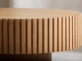 Close-up of the Udine Natural Wood Veneer Fluted Pedestal Coffee Table: the ring of fluted slats under the notched rim of the top