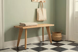 Umbertide bench in a Charleston entry hall with a sage-green plaster wall, a black-and-white checkerboard marble floor and a seagrass basket