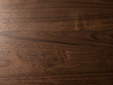 Close-up of the Urbino Acacia Veneer Faceted Coffee Table: the walnut-stained acacia veneer grain of the top