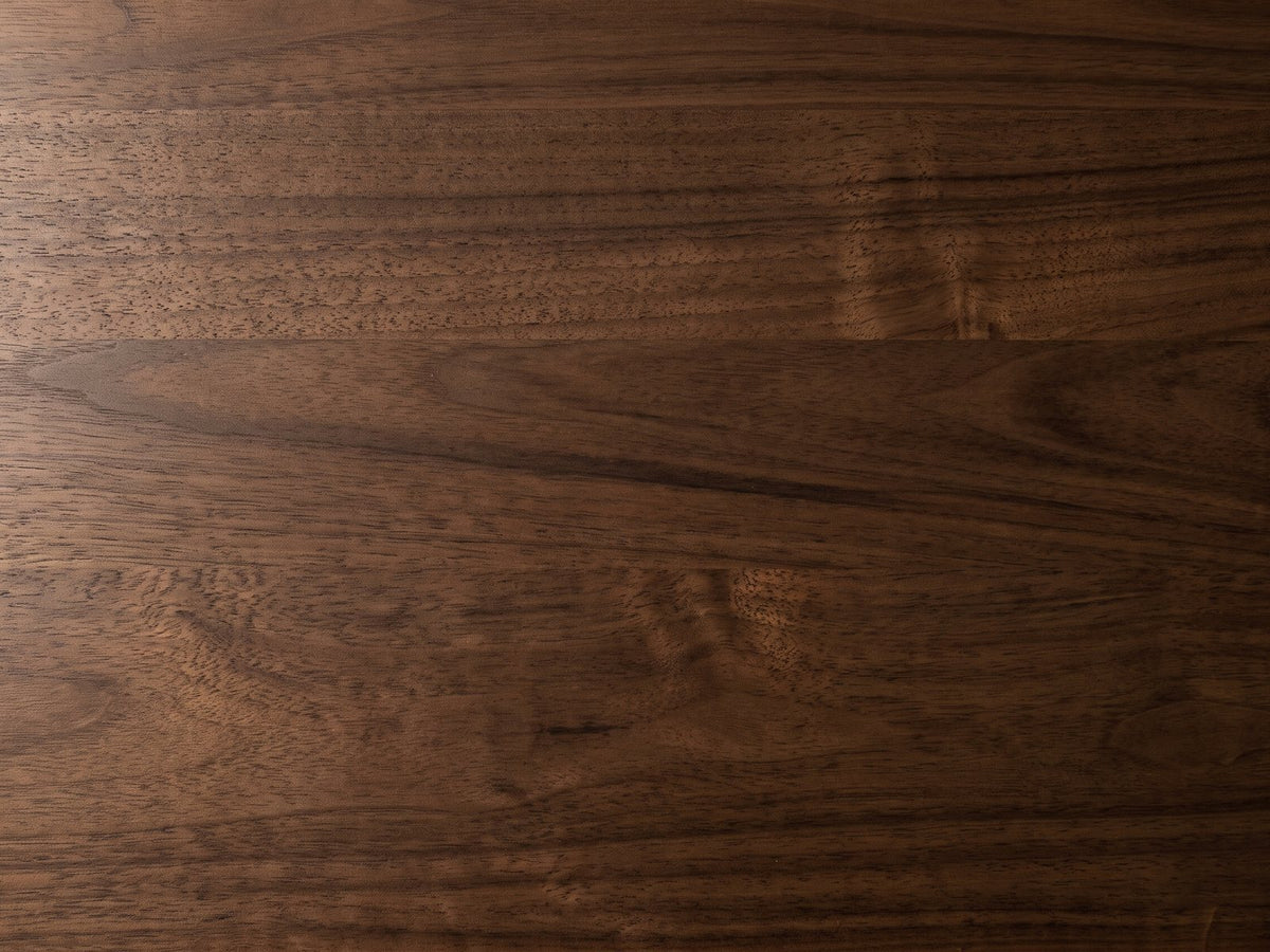 Close-up of the Urbino Acacia Veneer Faceted Coffee Table: the walnut-stained acacia veneer grain of the top