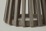 Close-up of the acacia on the Valderice side table: slat ends and the floor ring in a weathered grey finish with the grain showing