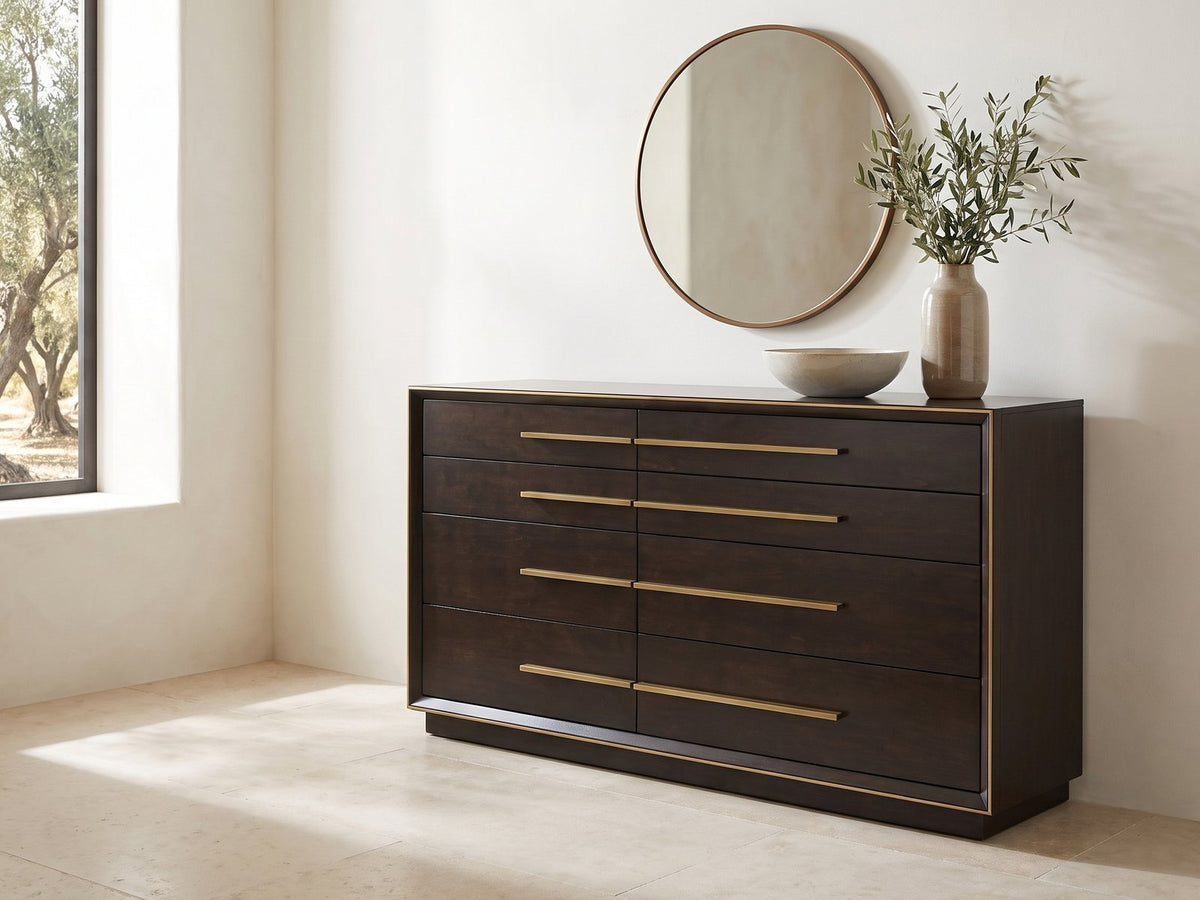 Valeggio 70-Inch Smoked Peppercorn 8-Drawer Dresser under a round bronze mirror in a villa bedroom