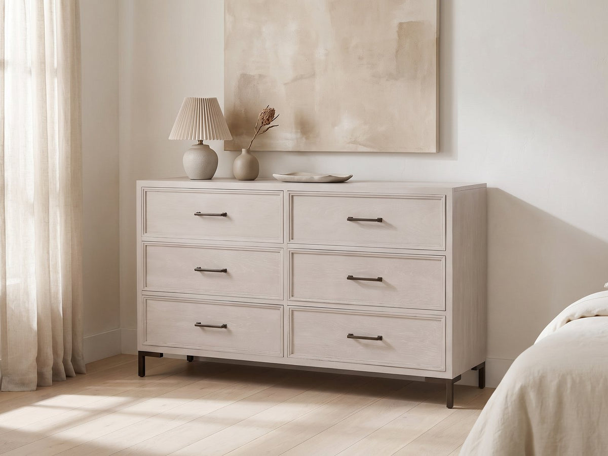 Venzone 64-Inch Cerused Oak 6-Drawer Dresser against a plaster wall under an abstract canvas in a bright bedroom